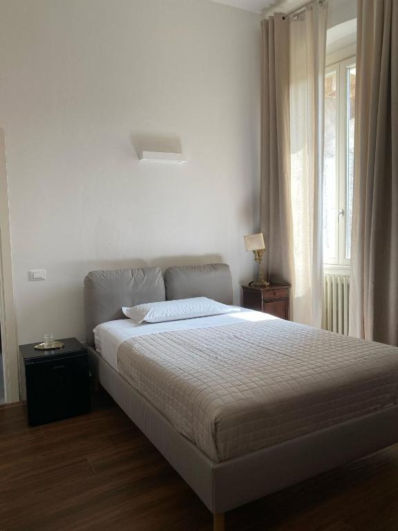 Postel nebo postele na pokoji v ubytování Residenza Scaligera