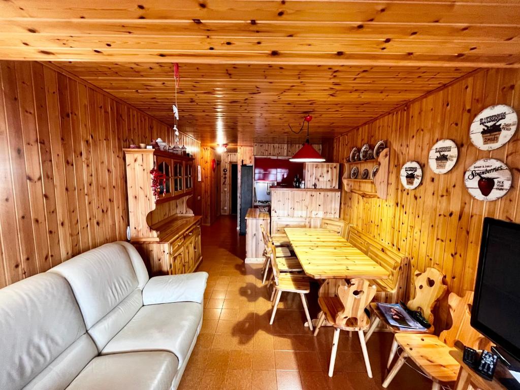 a living room with a couch and a table at Tormentina - Piancavallo in Piancavallo