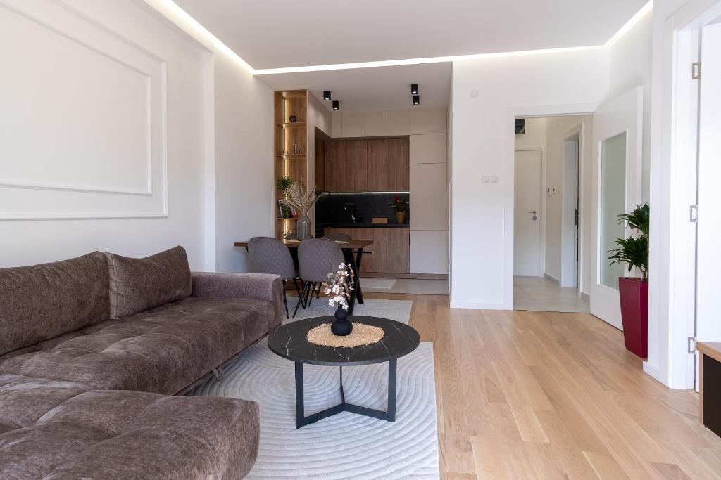 ein Wohnzimmer mit einem Sofa und einem Tisch in der Unterkunft City Luxury in Trebinje