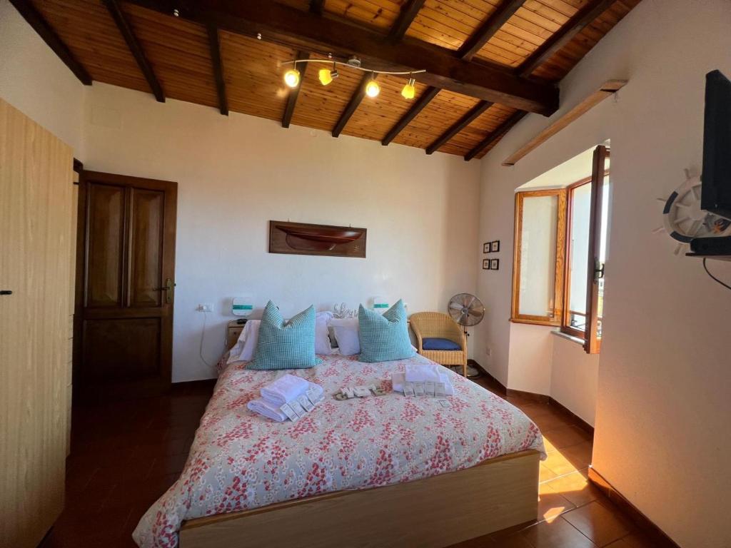 a bedroom with a large bed with blue pillows at Casa Giambi in Corniglia