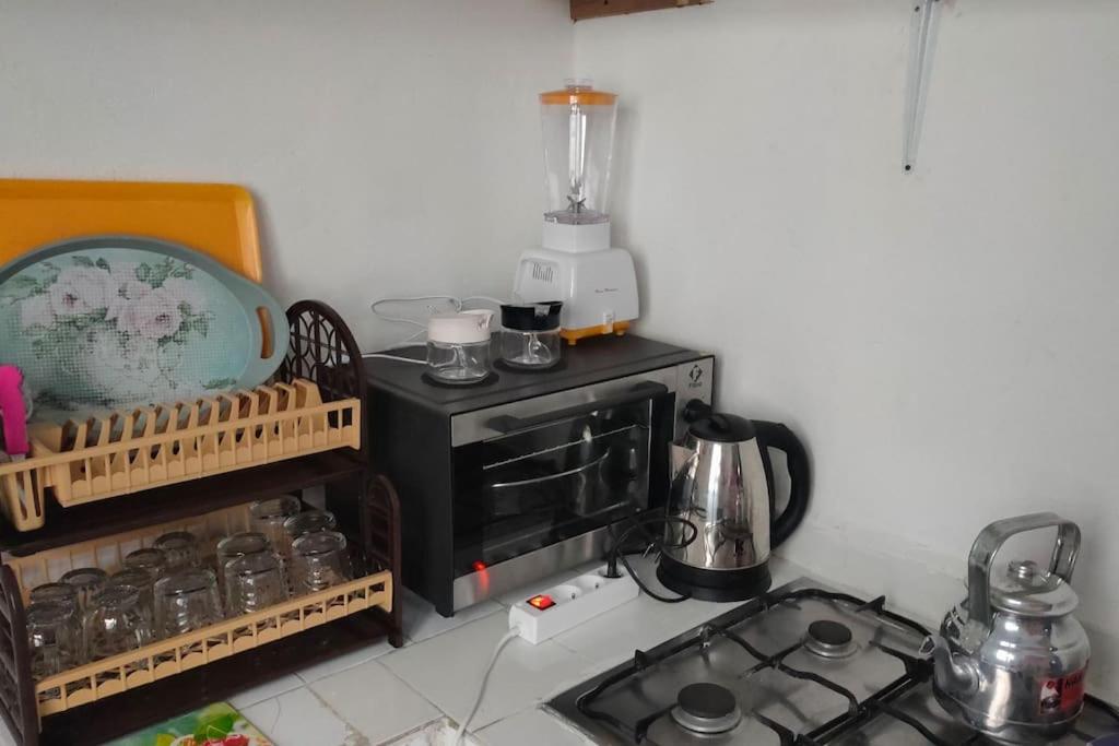 a small kitchen with a stove and a microwave at j appartement in Essaouira