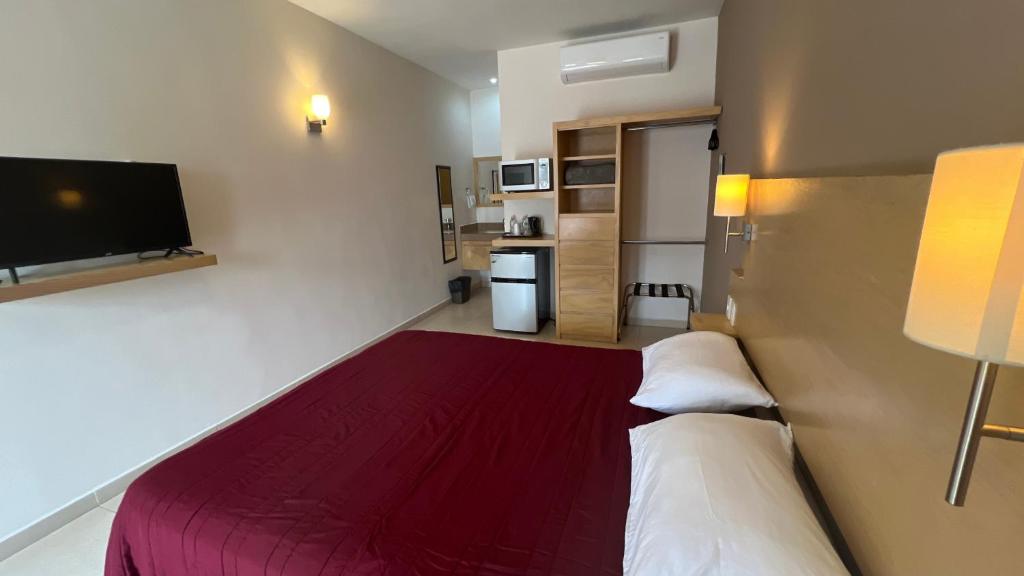 Postel nebo postele na pokoji v ubytování Nova Hotel