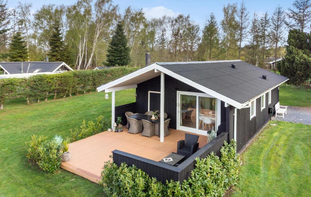 uma casa modular com um deque num quintal em Awesome Home In Vggerlse With Kitchen em Bøtø By