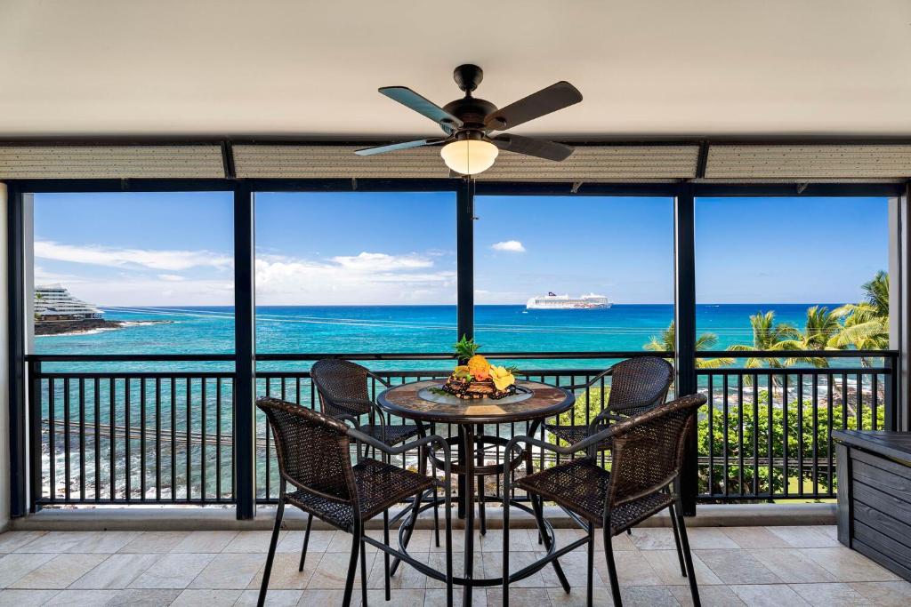 a dining room with a view of the ocean at Kona Alii 403 in Kailua-Kona