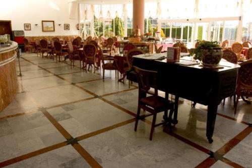 a dining room with a table and chairs in a room at Hotel Begoña Park in Gijón