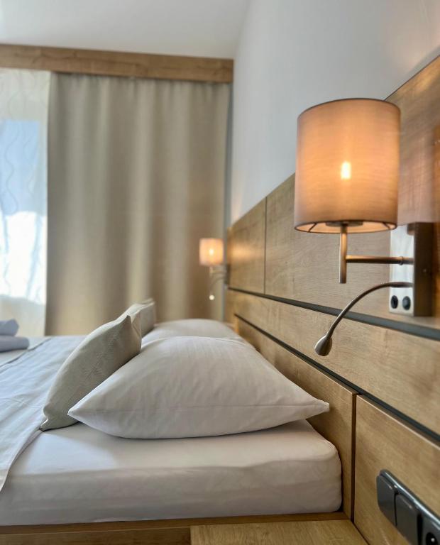 a bedroom with a bed with a lamp on it at Penzión Darinka in Poprad