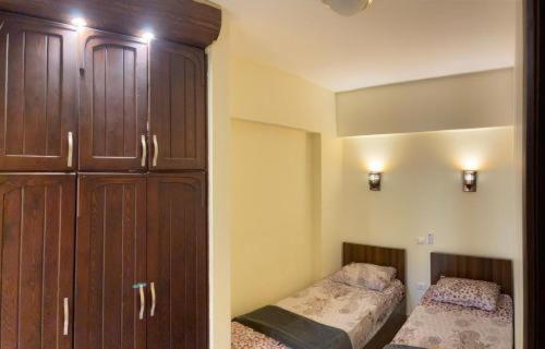 a bedroom with two beds and a large closet at Wadee hous in Hurghada