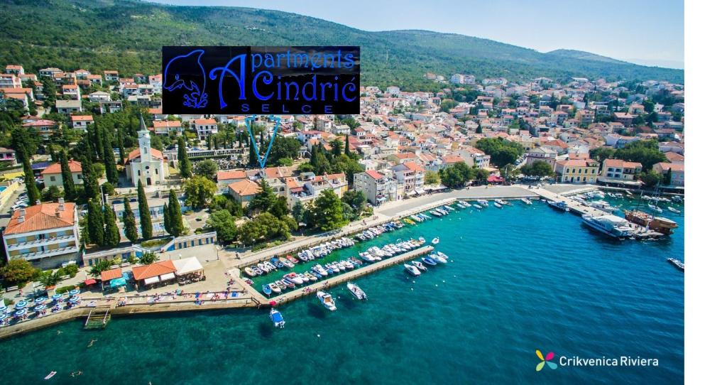 an aerial view of a city with boats in the water at Apartments Cindrić in Selce