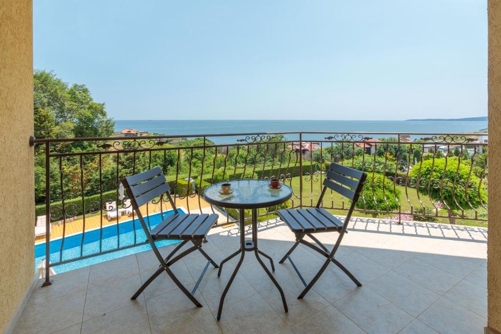 a table and two chairs on a balcony with a view at Via Pontica 123 Guest Apartments in Sozopol