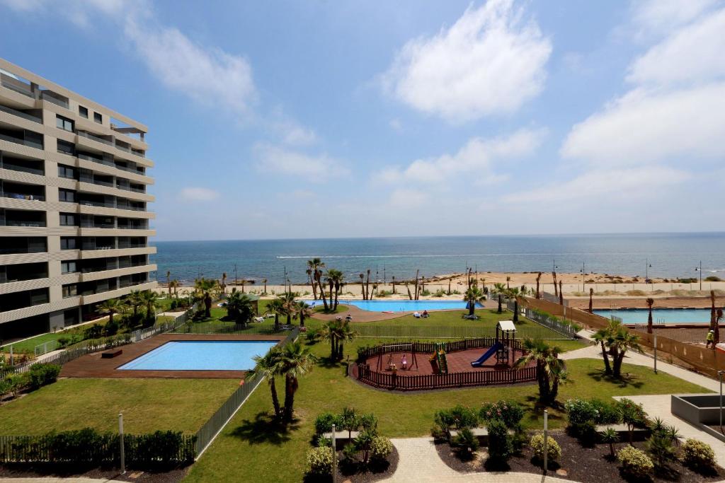 - une vue sur un complexe avec une piscine et l'océan dans l'établissement Luxury Panorama Mar by Grupo Quattro, à Punta Prima