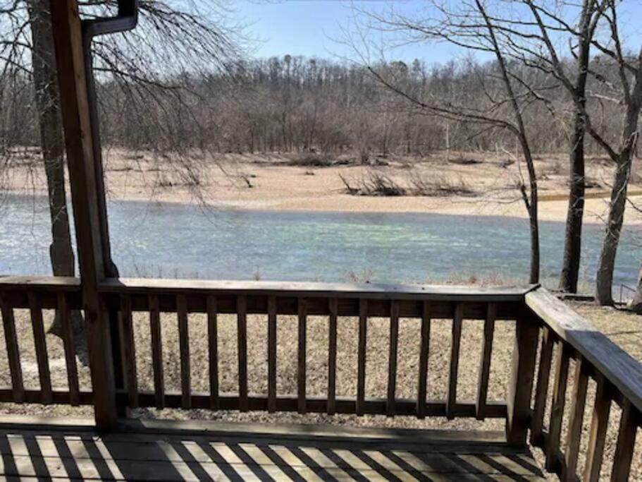 a porch with a view of a body of water at Current River Getaway in Van Buren