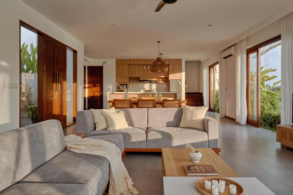 a living room with a couch and a table at Om Cemagi Beach Villa Canggu in Canggu