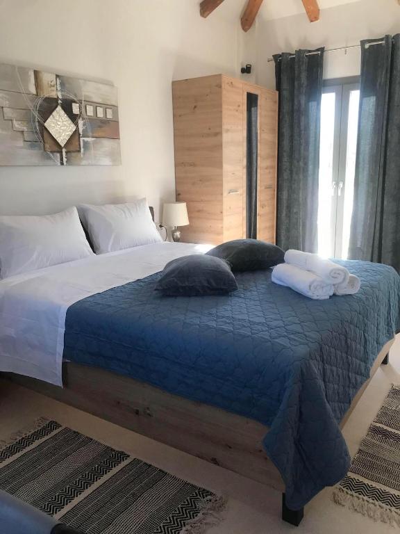 a bedroom with a large bed with towels on it at Ktimavita Apartment 1 in Petra
