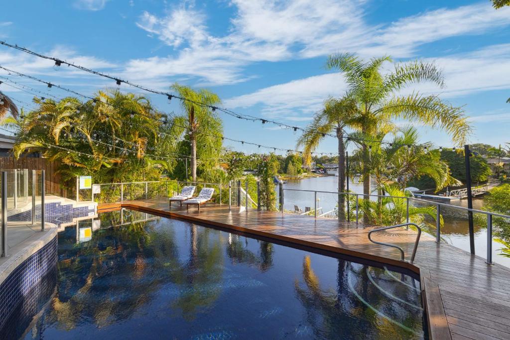 a swimming pool with a view of a body of water at Habourlights 5BR River Front Private Pool & Dock in Gold Coast