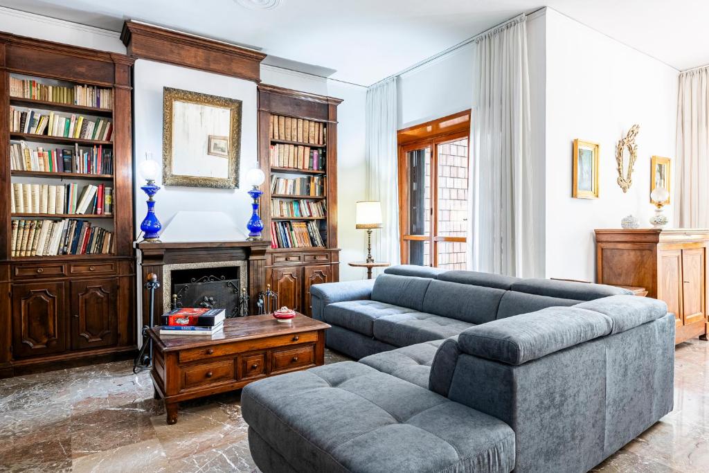 a living room with a couch and a fireplace at [Lungarno] Casa esclusiva in Florence
