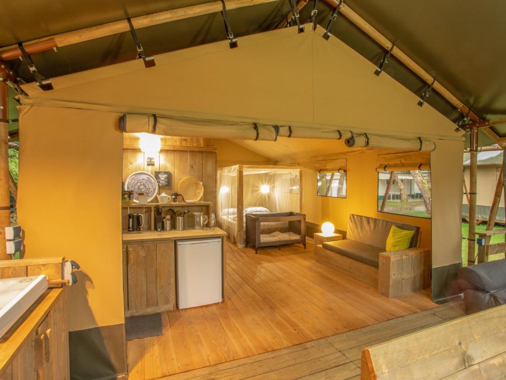 an open living room and kitchen in a tiny house at Lodge Holidays - Les 3 Cantons in Saint-Antonin