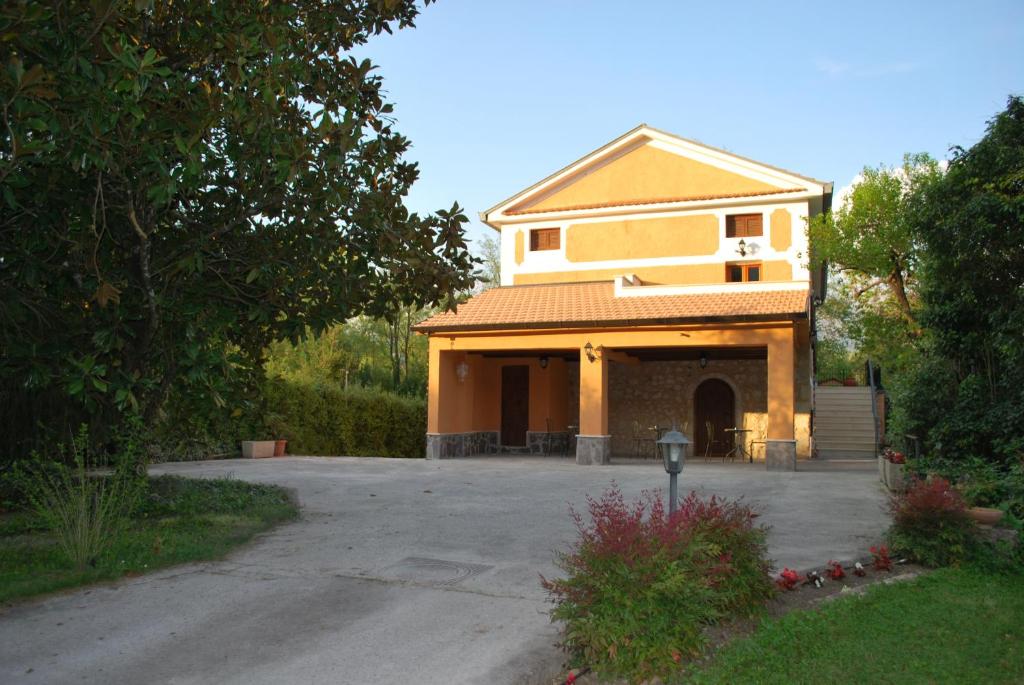 ein großes gelbes Gebäude mit Parkplatz in der Unterkunft Villa Visocchi Bed and Breakfast in Atina