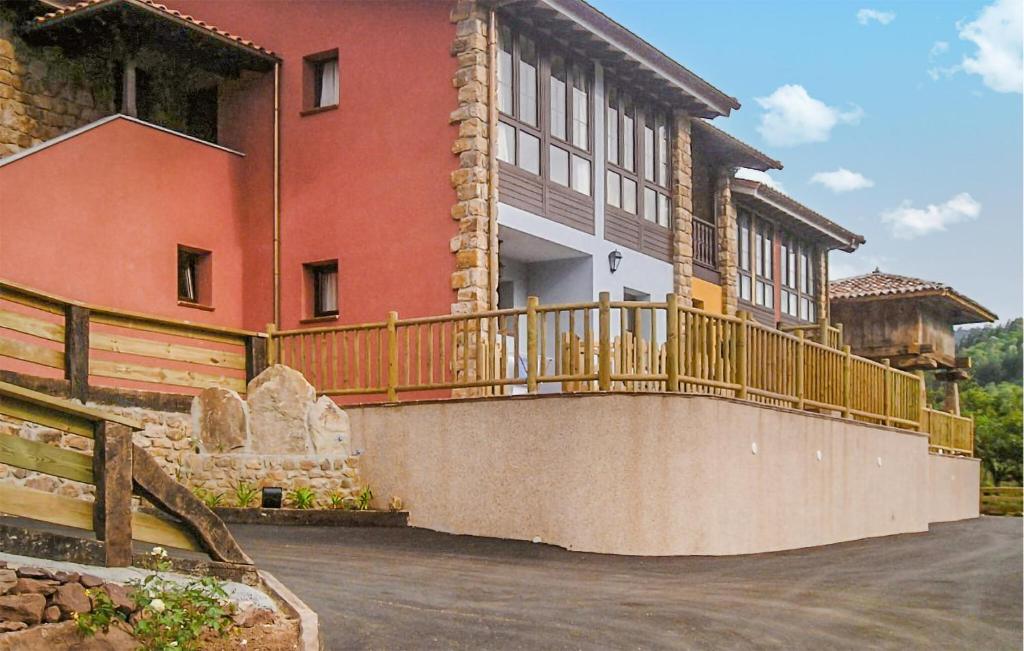 a large house with a wooden deck on a driveway at 2 Bedroom Lovely Apartment In Villaviciosa in Villaviciosa