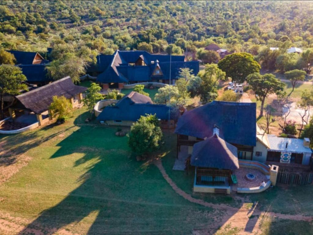 an aerial view of a house with blue roofs at Bushveld Venue in Mabula