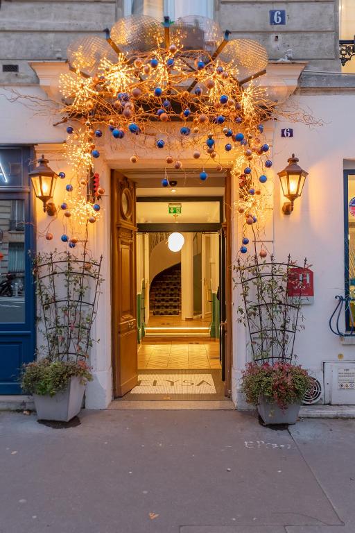 an entrance to a building with christmas lights at Hotel Elysa-Luxembourg in Paris