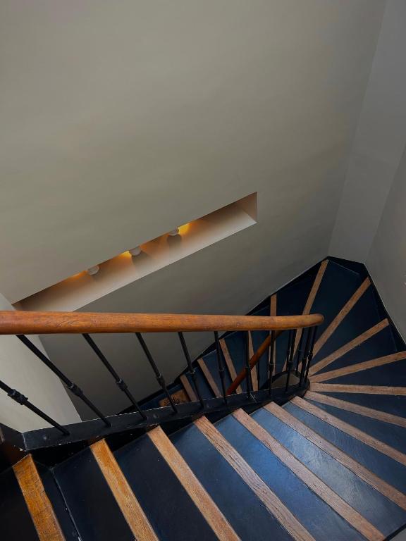 a spiral staircase in a building with blue stairs at Maï Homes - La Villa Bompard in Marseille