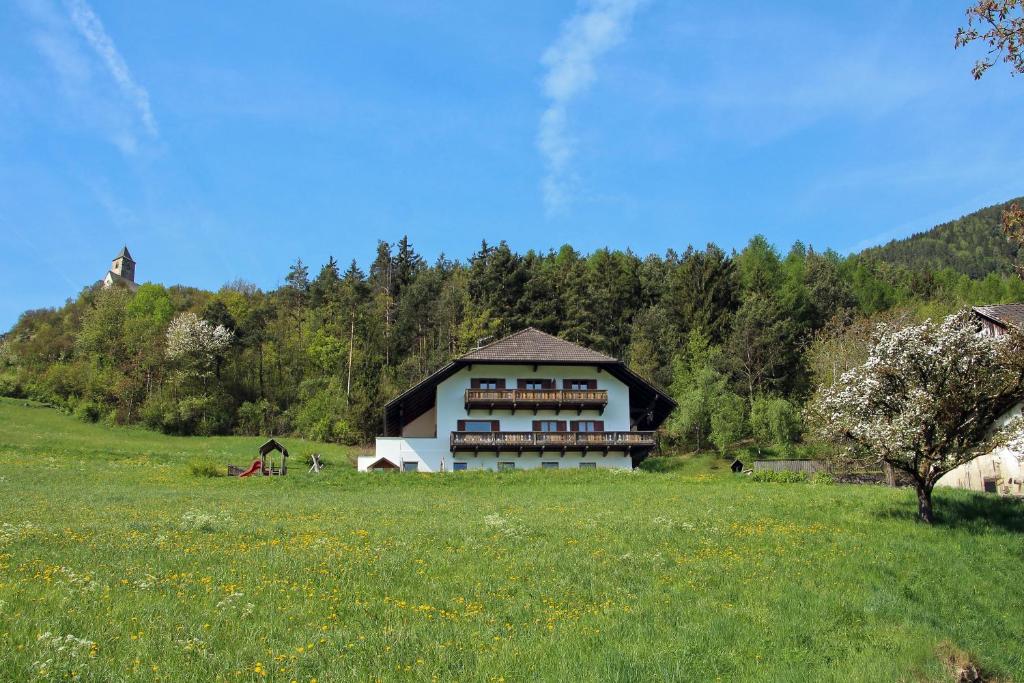 a house on a hill in a field of grass at Pirchnerhof in Longomoso