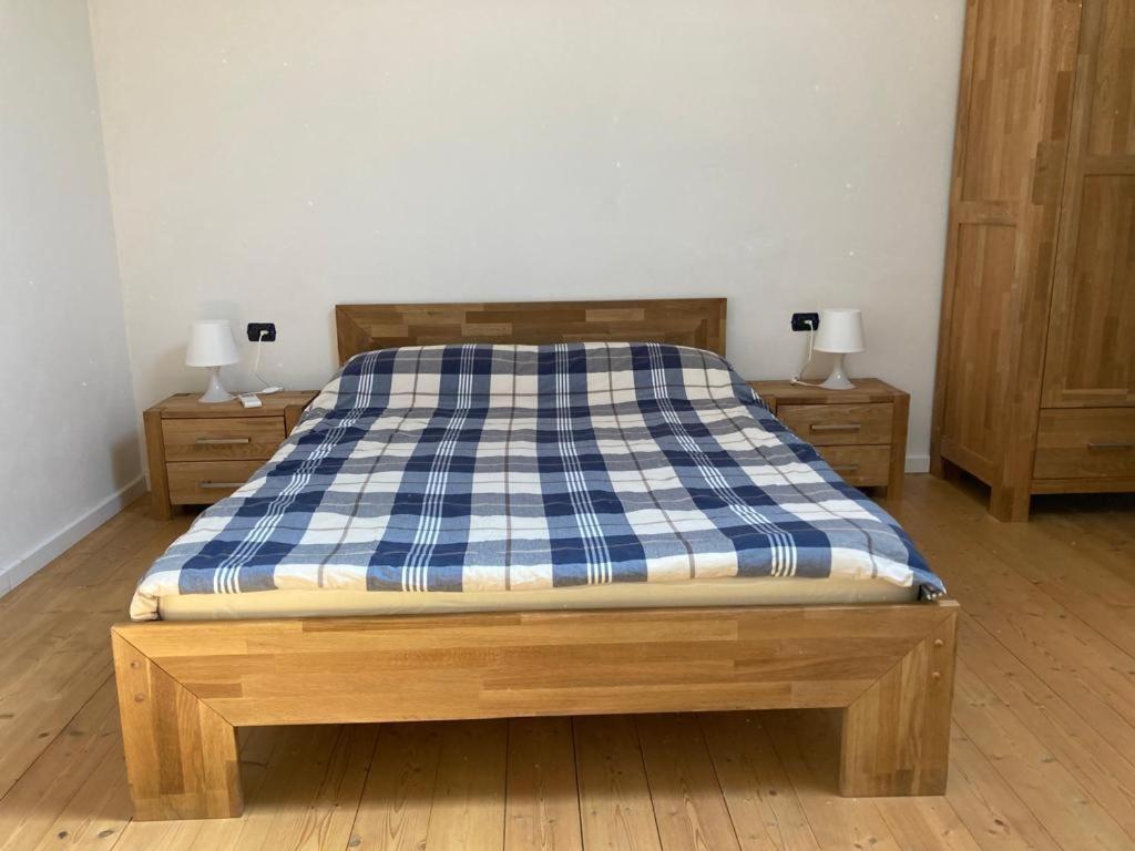 a bed with a blue and white checkered mattress at La Suite Sotto Stelle in Oristano