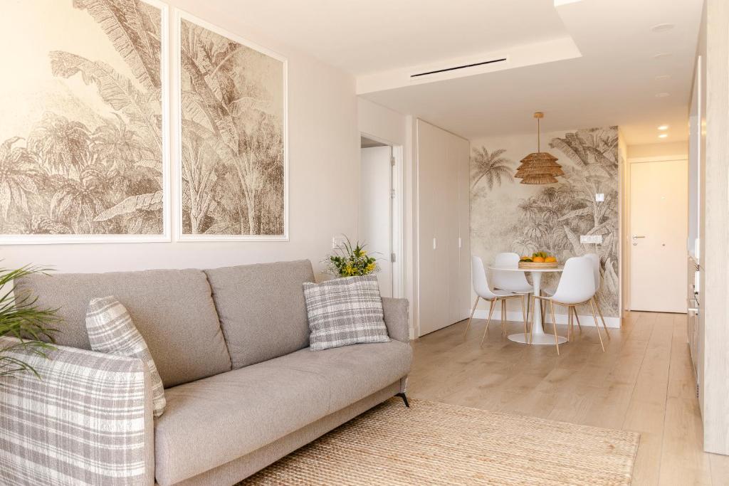 a living room with a couch and a table at Las Canteras con Alma in Las Palmas de Gran Canaria