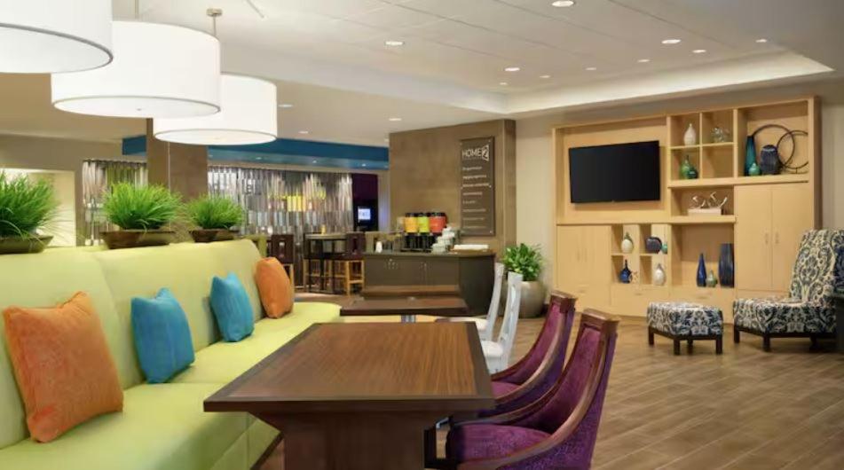 a lobby with a table and chairs and a television at Home2 Suites By Hilton American Canyon Napa Valley in American Canyon