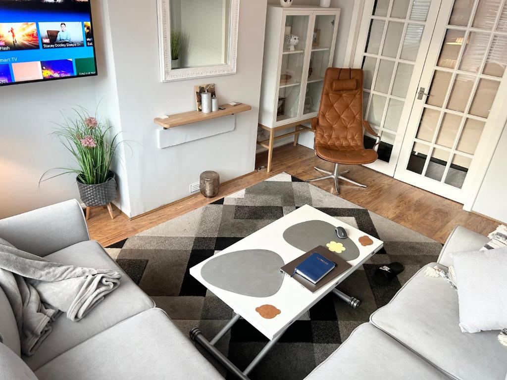 a living room with a couch and a table at The Heath Retreat in Kent