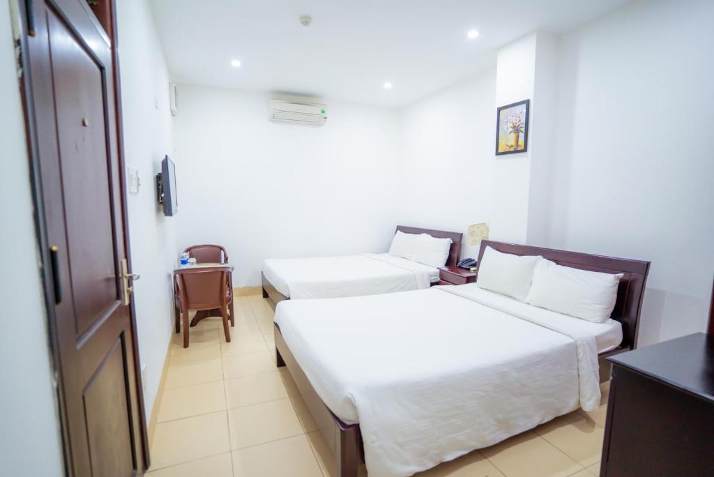 Postel nebo postele na pokoji v ubytování Lotus Rock Hotel Đà Nẵng