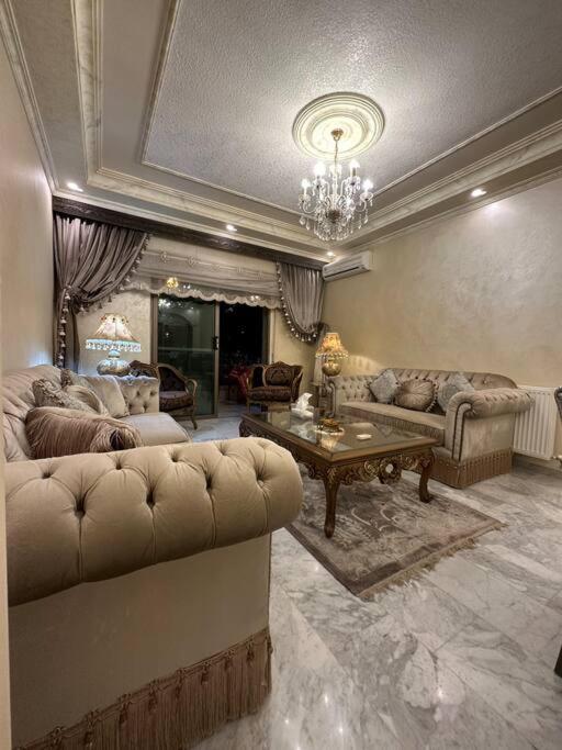 a living room with a couch and a table at 3bedroom apart at-Al Kursi in Amman
