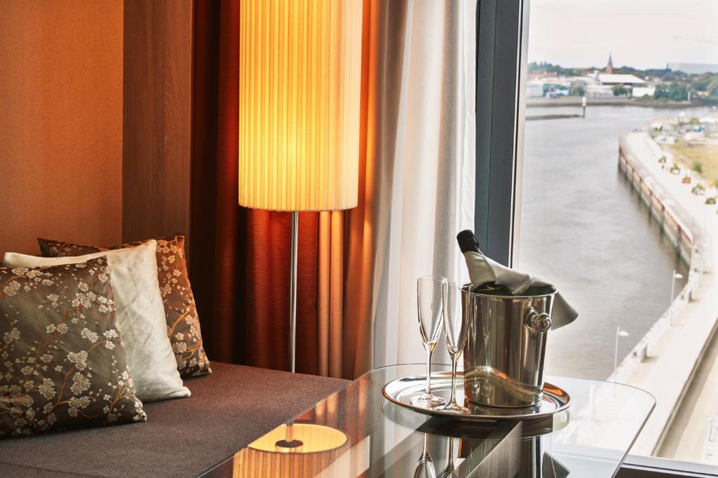 a bottle of wine on a table next to a window at Steigenberger Hotel Bremen in Bremen