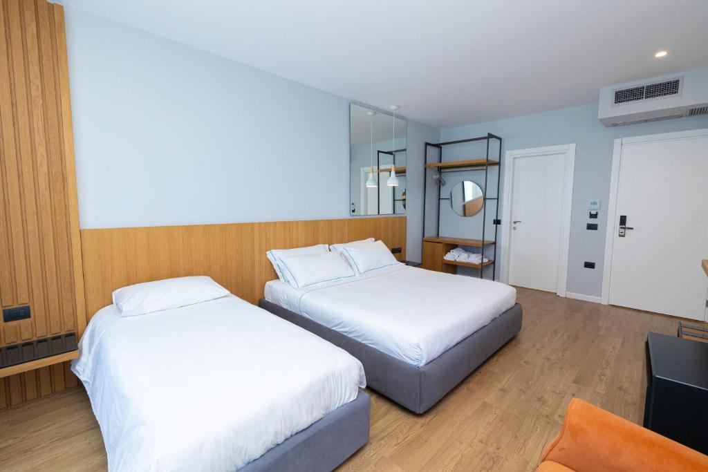 Postel nebo postele na pokoji v ubytování DUKA Hotel