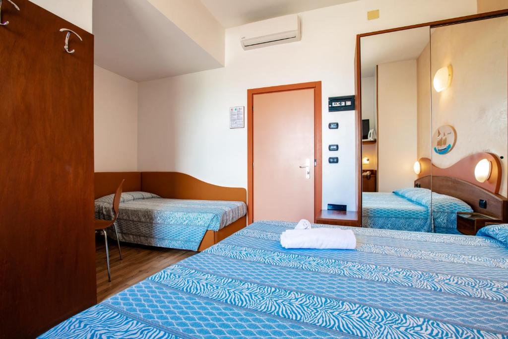 Postel nebo postele na pokoji v ubytování Miramare Hotel Ristorante Convegni