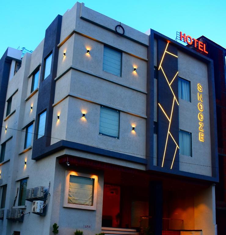 a building with a sign on the side of it at HOTEL SNOOZE in Jaipur