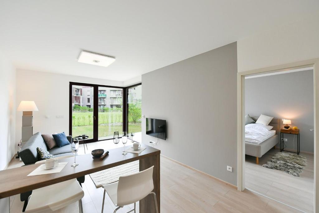 a living room with a desk and a bedroom at Golf Apartment 114 in Beroun