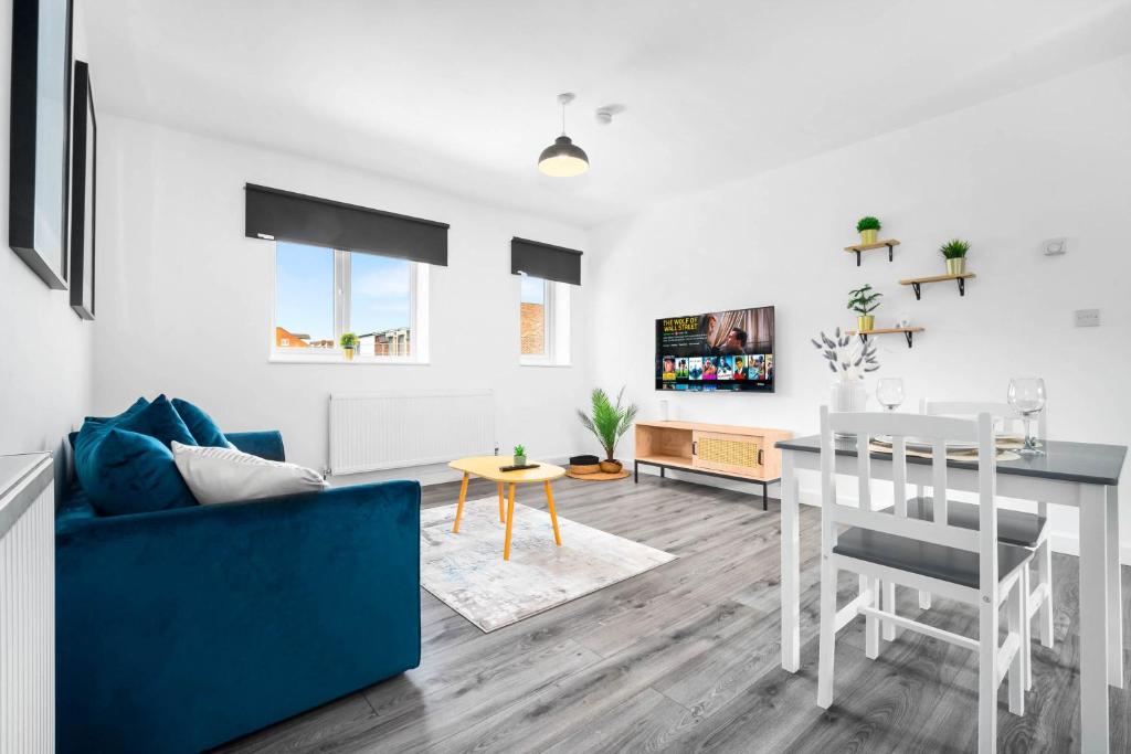 a living room with a blue couch and a table at New Luxury Apartment - Cradley Heath - 2MH - Parking - Netflix - Top Rated in Birmingham
