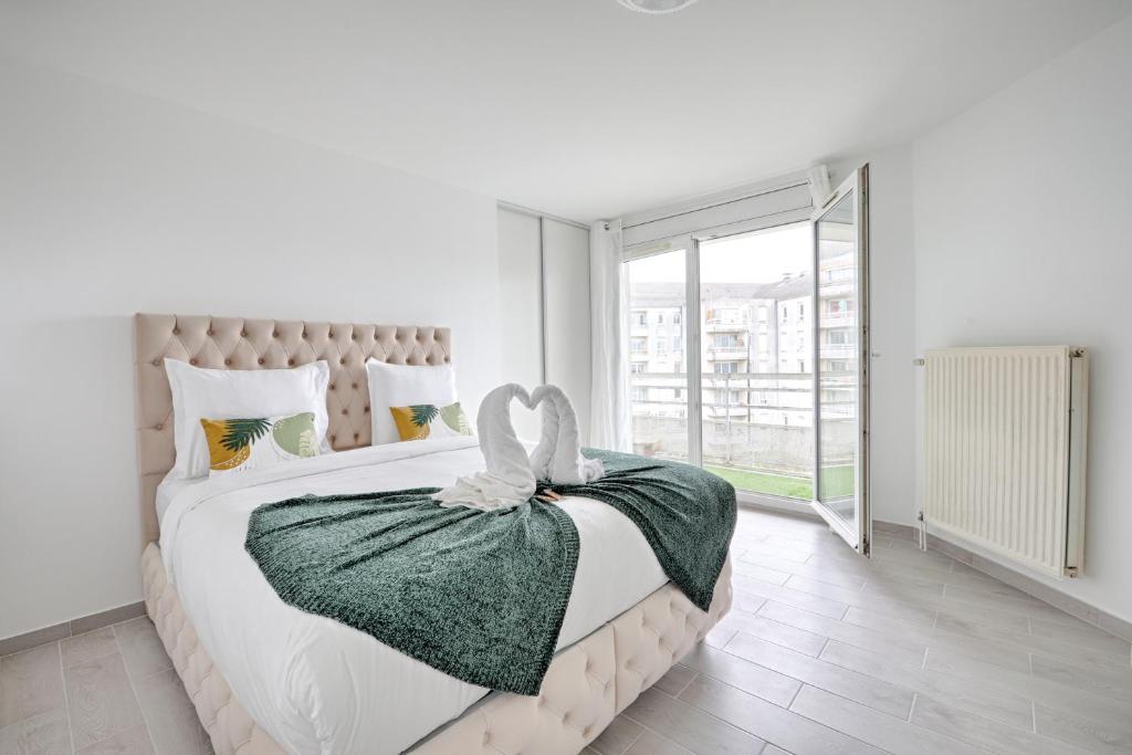 - une chambre blanche avec un lit et une grande fenêtre dans l'établissement Les Sarrazines - 2 voyageurs - Parking privé, à Créteil