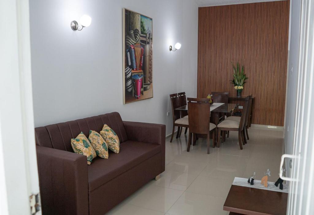 a living room with a couch and a dining room at APARTAMENTO - AIRE ACONDICIONADO in Valledupar