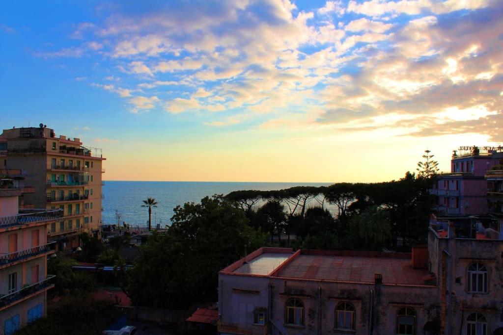 a view of the ocean from a city at sunset at Le Case della Costa - Appartamento Capri in Maiori