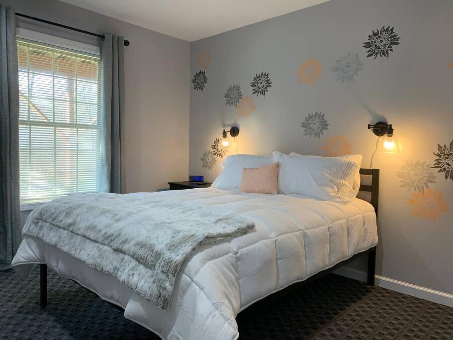 a bedroom with a large white bed with snowmen on the wall at Private Suite in Davison in Davison