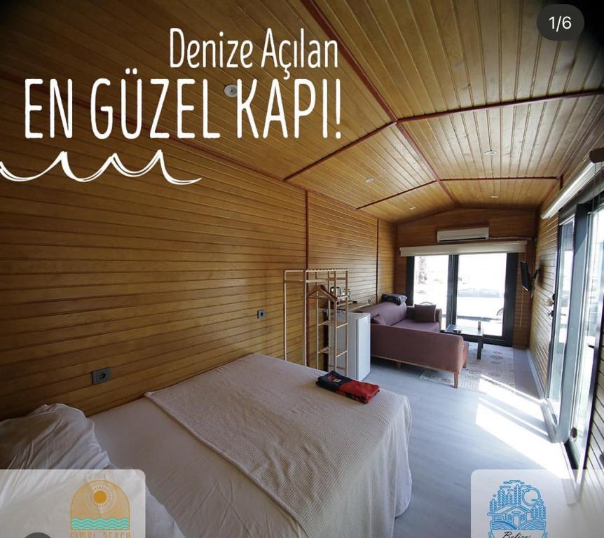 a bedroom with a bed and a couch in a room at Belize suit otel in Muğla