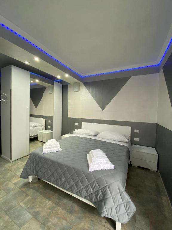 a bedroom with a large bed with a blue light at Bellavista B&B in Roccavivara