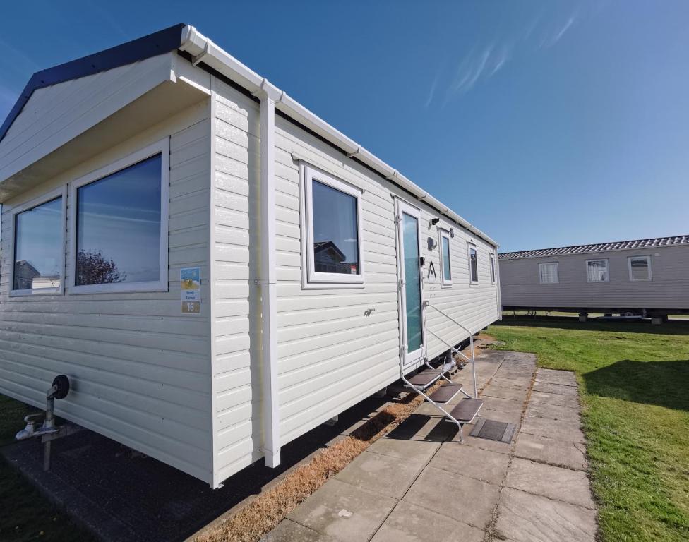a white tiny house in a yard at Sea activities Golden Sands beach relax in Mablethorpe