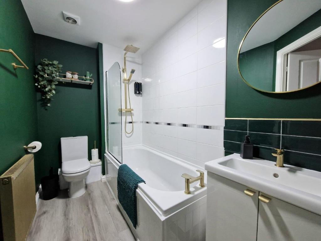 a bathroom with a tub and a toilet and a sink at Impeccable 2-Bed Apartment in Newcastle upon Tyne in Newcastle upon Tyne