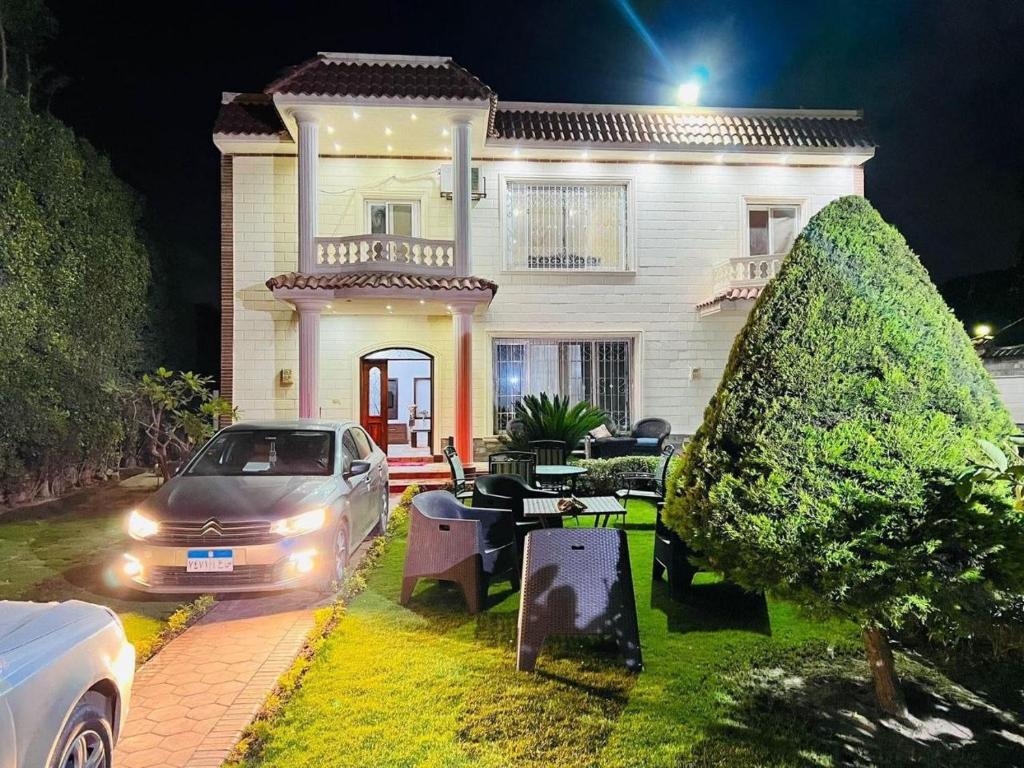 a car parked in front of a house at night at private Villa with a special view in Qaryat Shākūsh