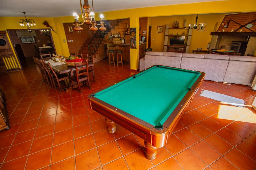 a living room with a pool table in the middle at Quinta de São Francisco in Cinfães