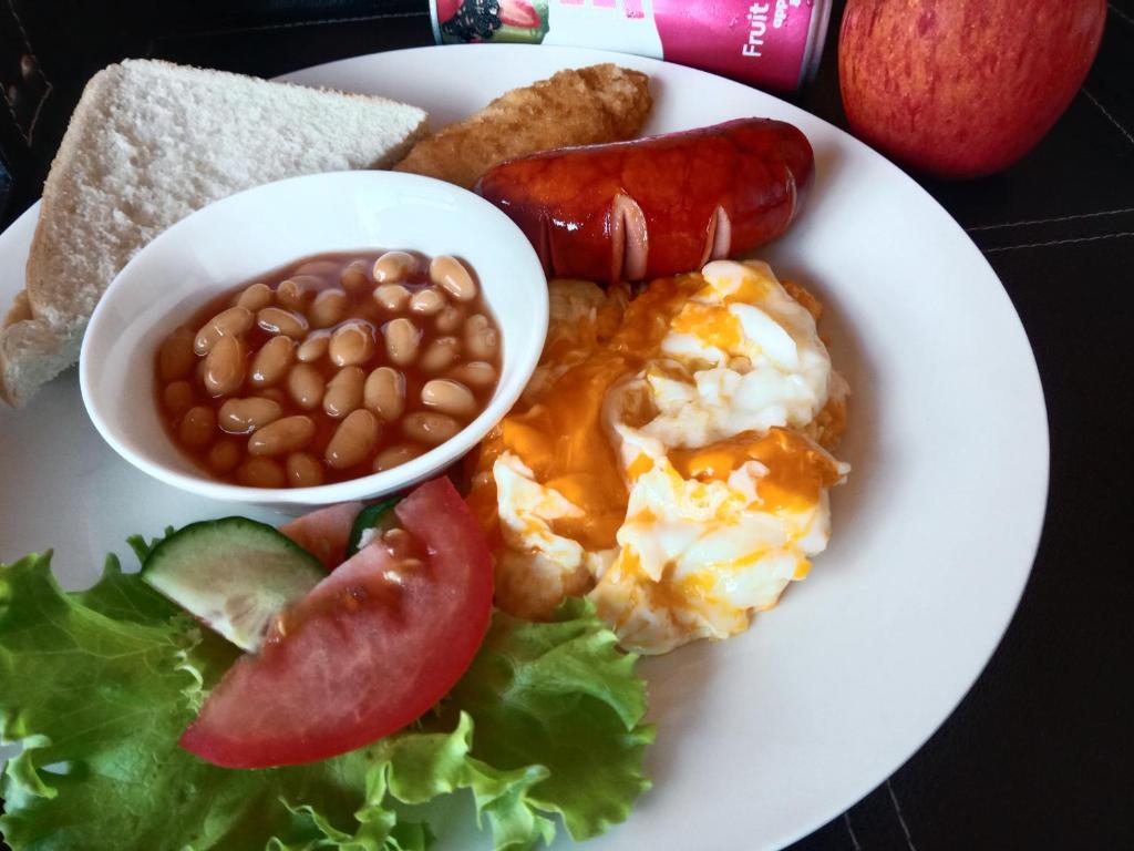 a plate of food with eggs beans beans and a salad at Edladleni Guesthouse Quigney in East London