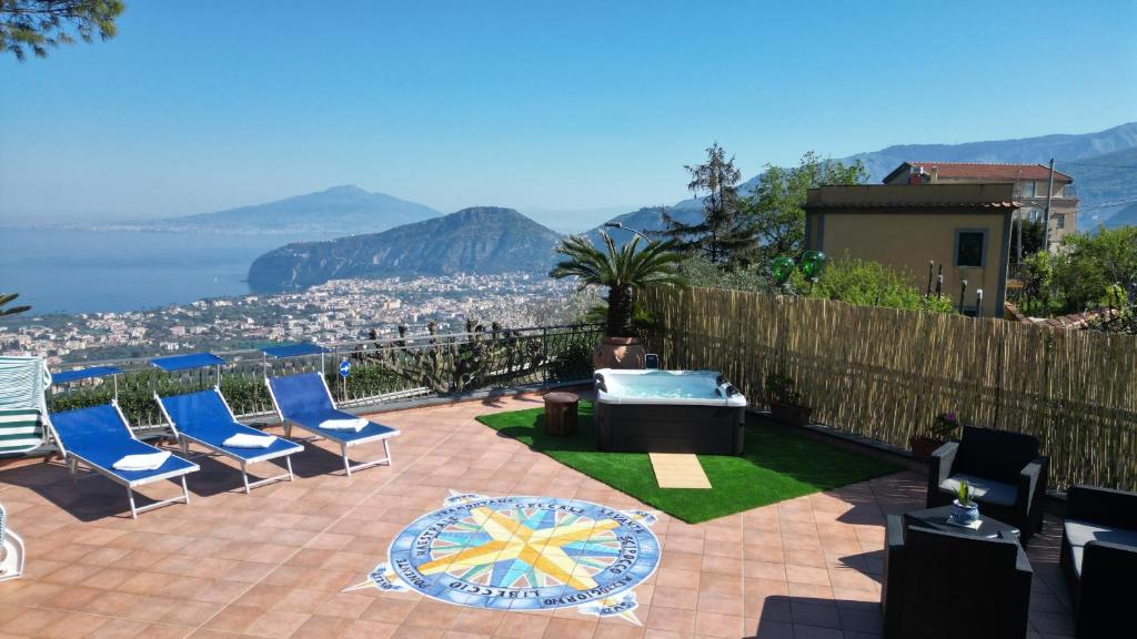 a patio with chairs and a table with a view at Villa Due Golfi in Colli di Fontanelle